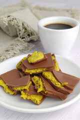 Trend dessert - Dubai style chocolate with coffee on the table. Close-up