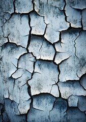 Obraz premium A high-resolution texture of an old, cracked white wall with subtle gray tones and a rough appearance. The background is a dark blue to contrast the grunge surface.