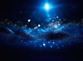 Dark blue, grainy textured landscape with sparkling lights.  A bright light source illuminates the undulating surface, creating a sense of depth and mystery.