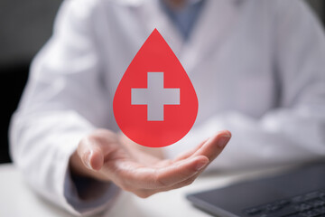 Professional health care worker doctor physician holding blood icon for blood donation concept