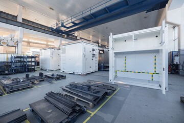 Industrial factory interior with metal components and large white equipment units
