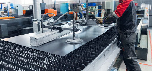 Industrial factory metal processing with advanced machinery and technician, Vacuum transporter to cnc laser