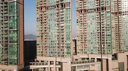 Skyscrapers in Hong Kong with green windows. Bottom-Up view