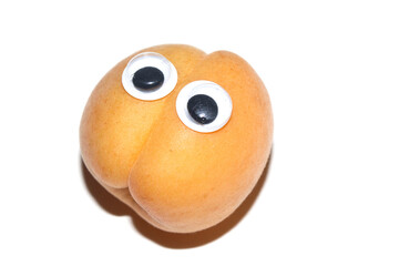 Close up of a fresh apricot fruit with Boggle Eyes Silly