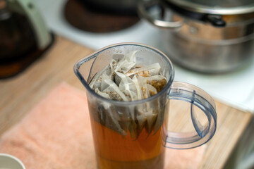 plastic pitcher filled with brewed herbal tea bags designed for soothing baths for children. Perfect for relaxation and calming bath time experiences