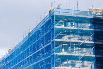 Scaffolding surrounding residential development for safe access to construction work