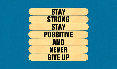 Never Give Up Symbol. Concept word Stay Strong Stay Positive Never Give Up on beautiful wooden...