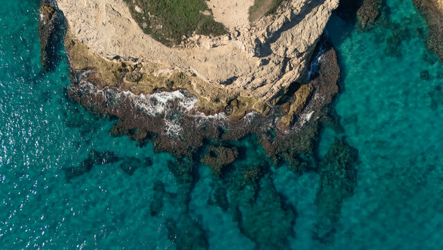 Jagged rocky steep coast of southern Puglia with deep blue clear sea water on sunny day, Italy - Powered by Adobe