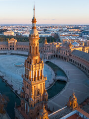 Fototapeta premium Plaza de España aerial view with tower, palace and square at sunrise, Seville, Spain