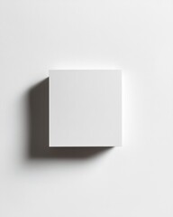 Minimalist white cube on a white surface with shadow