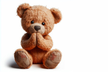Obraz premium An old teddy bear in a sitting position. Space for text.