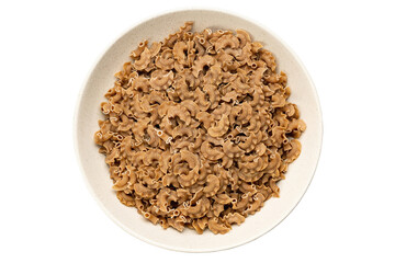 Raw paste in a bowl isolated on white background, italian food. Close-up view from the top.