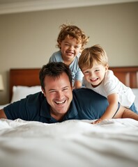 Fototapeta premium A man lays comfortably on a couch with two girls playfully on him