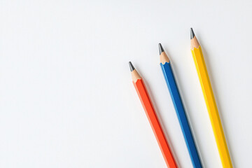 Colorful pencils arranged on blank background, perfect for creativity