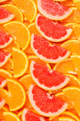 Slices of oranges and a grapefruits as a background.