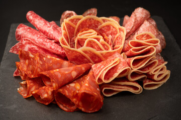 Different kinds of meat cuts on a board.