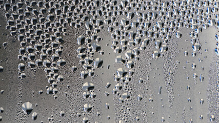 background, unusual, abstract. drops of morning dew, condensation on the glass. wet glass. water drops close-up. beautiful background for text. Spray cool condensate water on the glas