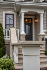 Elegant Home Exterior with Classic Porch and Columns. Beautiful architecture, landscaping, and stately entrance. Ideal for real estate listings and home design inspiration.