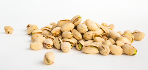 Roasted pistachios on white background