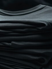 High-end commercial photography, pristine stack of black t-shirts meticulously folded on washing machine surface
