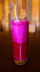 Refreshing Dragon Fruit Juice in a Tall Glass on Wooden Table