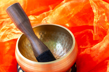 Tibetan Singing Bowl on Vibrant Orange Fabric