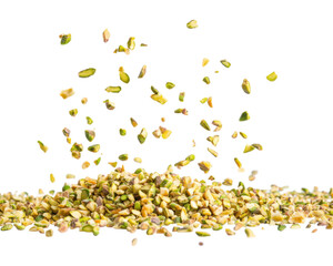 A pile of chopped pistachio nuts with some pieces floating above.