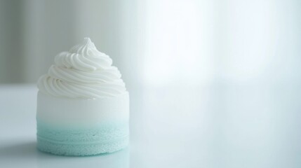 A white frosted cake with blue frosting on top