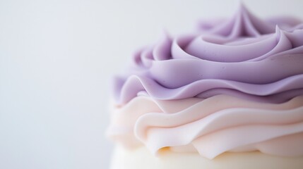 A cake with purple frosting and pink frosting