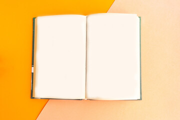 Open vintage mockup book on color geometric background, copy space for the text