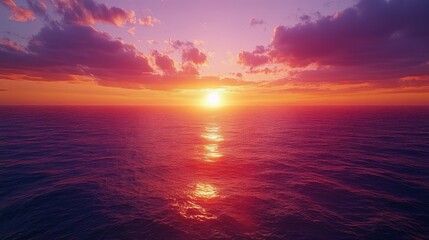 Fototapeta premium A stunning sunset over the ocean with vibrant colors. Great for themes of tranquility, nature, and relaxation.