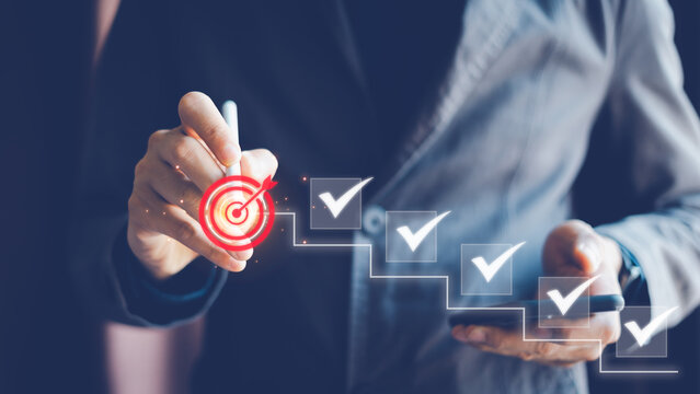 Business Success and Goal Achievement Steps, Businessman draws check mark on virtual ladder achieving goal, of success. Planning, progress, goal setting.