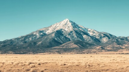 Naklejka premium Majestic snow capped mountain overlooking vast plains