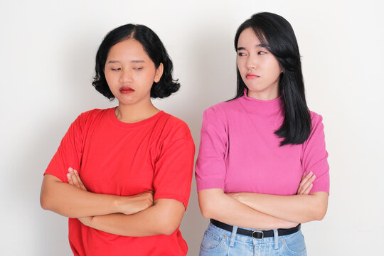 Two young girls standing next to each other showed annoyed expressions