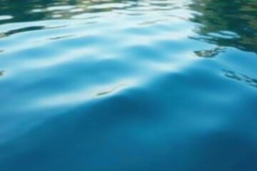 Obraz premium Gentle lapping of soft blue waves on a still pond surface, tranquility, waves