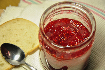 jam in a glass jar. glass jar with raspberry jam closeup.selective focus