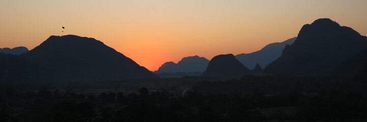 Colorful evening sky over mountains at sunset, Vang Vieng, Laos.