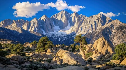Obraz premium Majestic Mountain Range Under a Blue Sky with Clouds