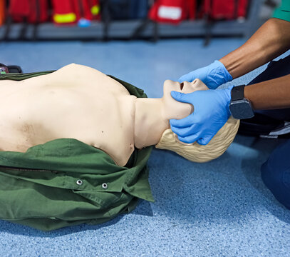 First aid CPR training clear airway with jaw thrust technique.