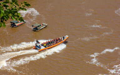 Igvasu Falls, on the border between Brazil and Argentina. Big boat with lots of tourists on board.