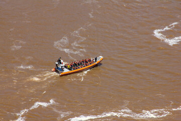 Igvasu Falls, on the border between Brazil and Argentina. Big boat with lots of tourists on board.