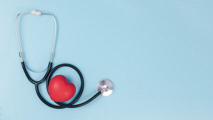 Stethoscope and red hearts on light blue background, Health care concept, World heart health day, Hospital life insurance concept, Doctor day, World hypertension day.