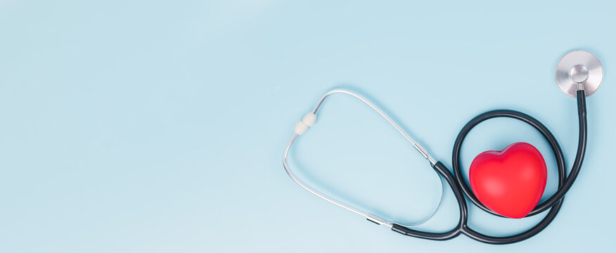 Stethoscope and red hearts on light blue background, Hospital life insurance concept, Health care concept, World heart health day, Doctor day, World hypertension day.
