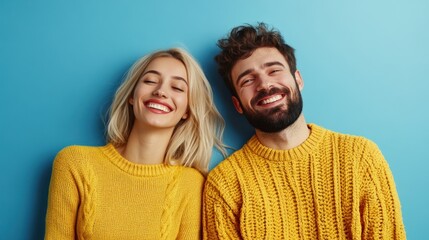 Obraz premium Happy Couple Wearing Matching Yellow Sweaters