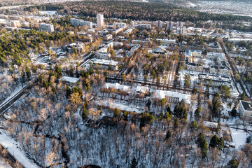 Aerial view of winter cityscape with snow-covered roofs