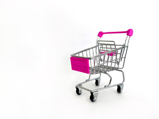 Miniature Shopping Cart With Pink Handles And Basket On White Background, Studio Setting, Ideal For Marketing Concepts, Online Shopping, E-Commerce, Retail Promotions, Business Advertising, Consumeris