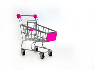 Miniature Shopping Cart With Pink Handles On White Background, Studio Setting, Perfect For Marketing Concepts, Retail Promotions, E-Commerce, Business Advertising, Consumer Awareness, And Sales Campai