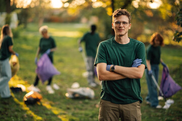 Young eco conscious volunteer posing with arms crossed during cleanup event