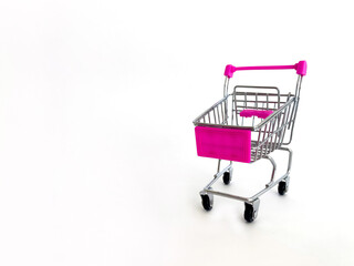 Miniature Shopping Cart With Pink Handles And Basket On White Background, Studio Setting, Ideal For Marketing Concepts, Online Shopping, E-Commerce, Retail Promotions, Business Advertising, Consumeris