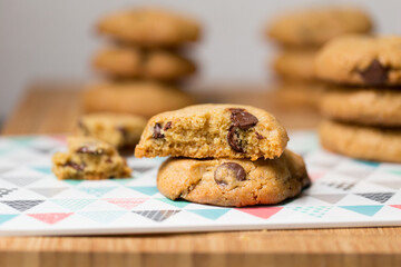 Close-up of half eaten chocolate chip cookies on a table with napkins
